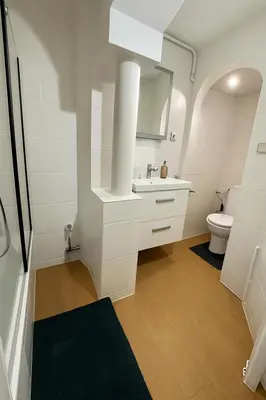 a white bathroom with a sink and a toilet at Brussels Central City Oasis in Brussels