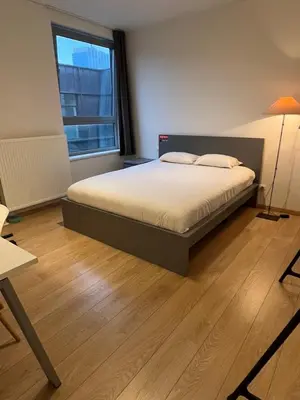 a bedroom with a bed and a large window at Urban Apartment 2 bedroom Brussels City in Brussels