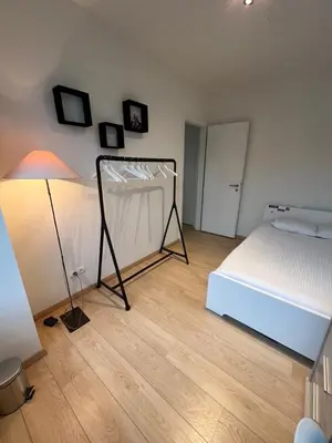 a bedroom with a bed and a lamp on a wooden floor at Urban Apartment 2 bedroom Brussels City in Brussels