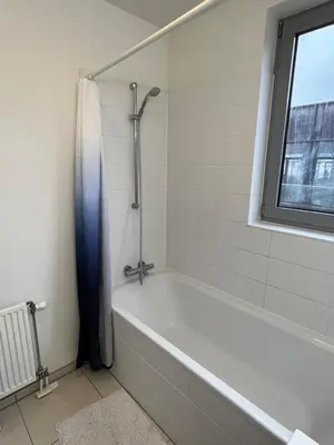 a bathroom with a bath tub and a window at Urban Apartment 2 bedroom Brussels City in Brussels