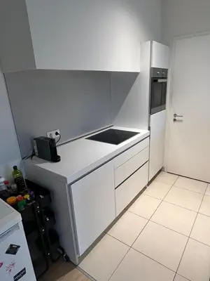 a kitchen with white cabinets and a refrigerator at Urban Apartment 2 bedroom Brussels City in Brussels