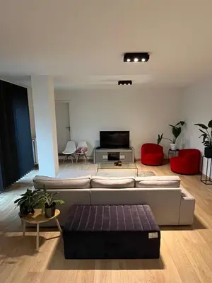 a living room with a couch and a tv at Urban Apartment 2 bedroom Brussels City in Brussels