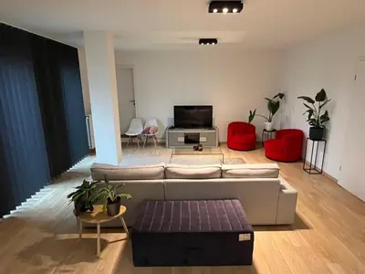 a living room with a couch and red chairs at Urban Apartment 2 bedroom Brussels City in Brussels