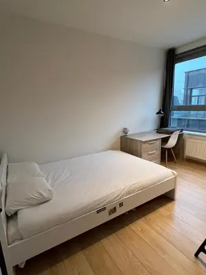 a bedroom with a bed and a desk and a window at Urban Apartment 2 bedroom Brussels City in Brussels