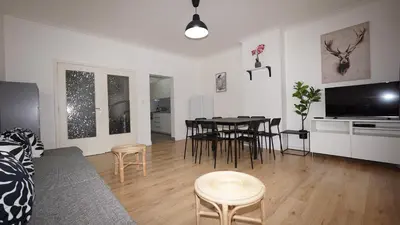 a living room with a table and a dining room at Amerika Apartments in Antwerp