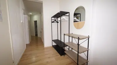 a hallway with a black book shelf and a mirror at Amerika Apartments in Antwerp