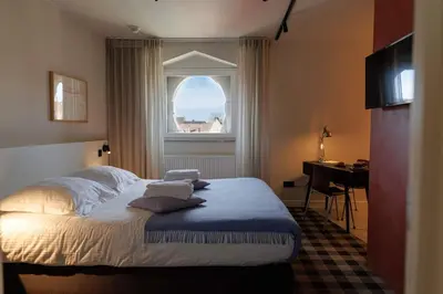 a bedroom with a bed with a window and a desk at Studio for 2 in City of Ghent in Ghent