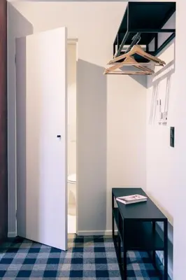 a room with a black table and a white door at Studio for 2 in City of Ghent in Ghent