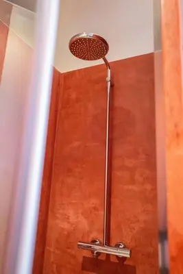 a shower with a shower head in a bathroom at Studio for 2 in City of Ghent in Ghent