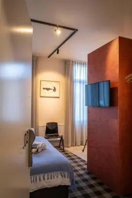 a hotel room with a bed and a tv at Excellent Studio for Two in Central Ghent in Ghent