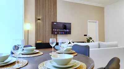 a living room with a table with wine glasses at Le Cocon Studio in Brussels