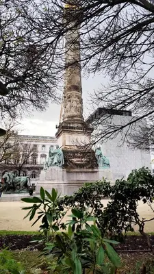 a monument with statues on it in a park at Le Cocon Studio in Brussels