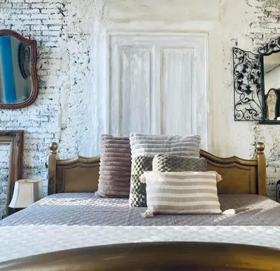 a bedroom with a bed with pillows on it at Mystic's Lodge in Antwerp