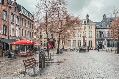 a city street with benches and tables and buildings at Mystic's Lodge in Antwerp