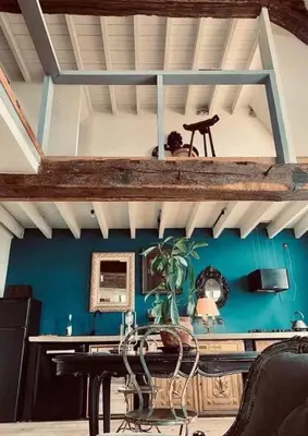 a room with a table and a blue wall at Mystic's Lodge in Antwerp