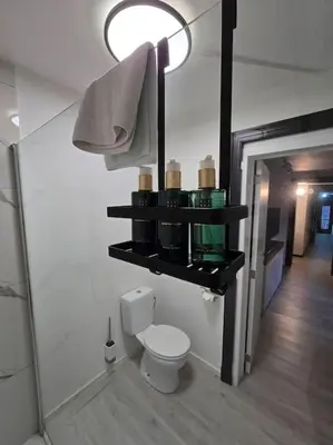 a bathroom with a toilet and a shelf with cosmetics at 8z dreamz 2 in Ghent