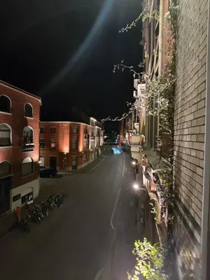 an empty city street at night with buildings and bicycles at 8Z Dreamz 3 in Ghent