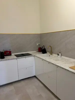 a white kitchen with white cabinets and a sink at 8Z Dreamz 3 in Ghent