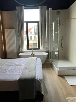 a bedroom with a bed and a tub and a window at 8Z Dreamz 3 in Ghent