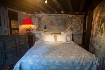 a bedroom with a large bed with a blue blanket at Living History - Drie Koningen in Antwerp