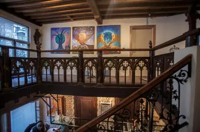 a staircase in a house with paintings on the wall at Living History - Drie Koningen in Antwerp