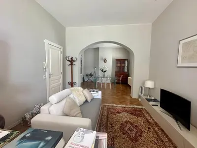 a living room with a couch and a tv at Beautiful luxurious 1 bedroom apartment in the heart of the European Quarter in Brussels