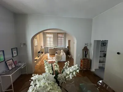 a living room with a vase of flowers on the floor at Beautiful luxurious 1 bedroom apartment in the heart of the European Quarter in Brussels