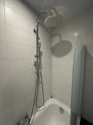 a bathroom with a shower and a bath tub at Beautiful luxurious 1 bedroom apartment in the heart of the European Quarter in Brussels