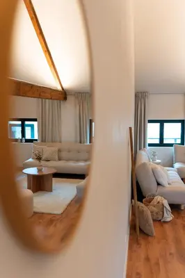 a living room with a couch and a table at Spacious, newly renovated loft - 107m2 in Sint-Niklaas
