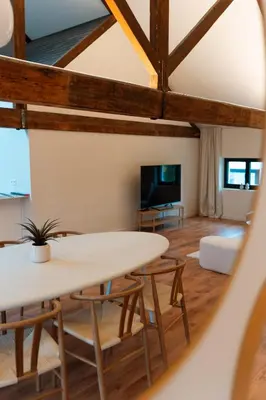 a living room with a white table and chairs at Spacious, newly renovated loft - 107m2 in Sint-Niklaas