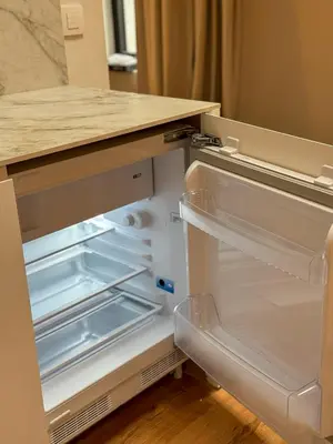 an empty refrigerator with its door open in a kitchen at Spacious, newly renovated loft - 107m2 in Sint-Niklaas