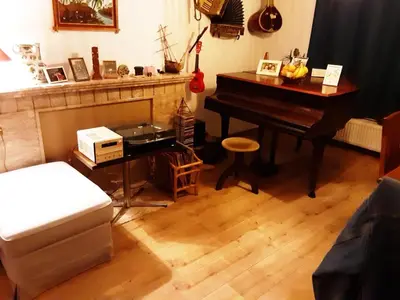 a living room with a piano and a table at Luxurious 2 bedroom appartment in Antwerp