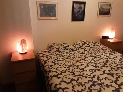 a bedroom with a bed and two night stands with lamps at Luxurious 2 bedroom appartment in Antwerp