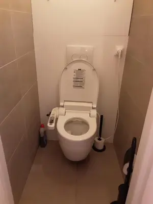 a small bathroom with a toilet with the lid up at Luxurious 2 bedroom appartment in Antwerp