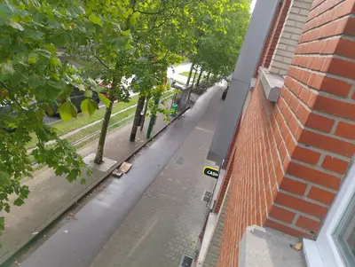 an empty street next to a brick building at Luxurious 2 bedroom appartment in Antwerp