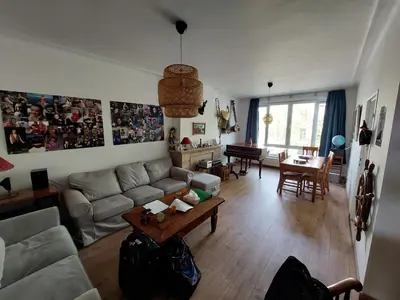 a living room with a couch and a table at Luxurious 2 bedroom appartment in Antwerp