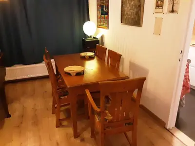 a wooden dining room table with chairs and a lamp at Luxurious 2 bedroom appartment in Antwerp