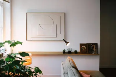 a living room with a couch and a plant at A Place Antwerp - Boutique Suites & Flats - Leeuwenstraat 20 in Antwerp