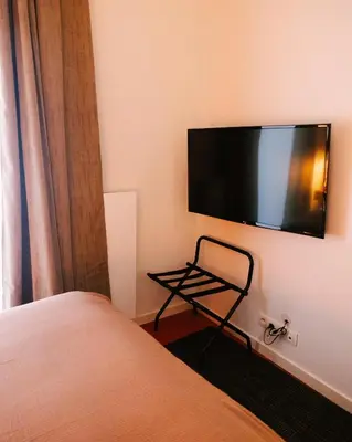 a bedroom with a bed and a flat screen tv on the wall at A Place Antwerp - Boutique Suites & Flats - Leeuwenstraat 20 in Antwerp