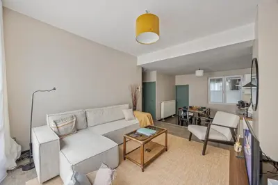 a living room with a couch and a table at Mubi-Stay - Appartement chalereux au centre ville D'Anvers in Antwerp