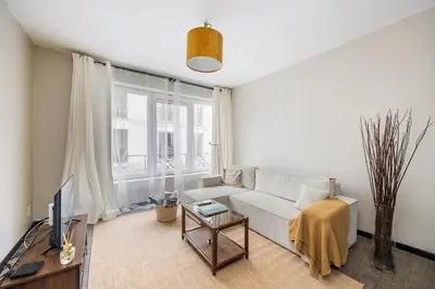a living room with a couch and a tv at Mubi-Stay - Appartement chalereux au centre ville D'Anvers in Antwerp
