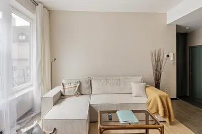 a living room with a couch and a table at Mubi-Stay - Appartement chalereux au centre ville D'Anvers in Antwerp