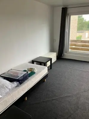 a room with a bed and a window in a room at Expats House 10 Stabroek Belgium in Stabroek