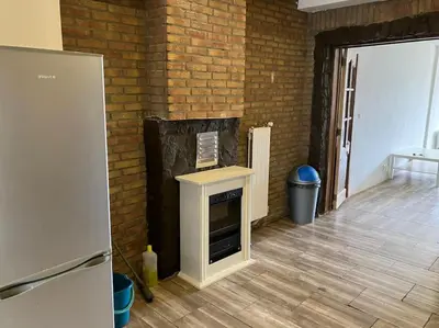 a room with a fireplace in a brick wall at Expats House 10 Stabroek Belgium in Stabroek