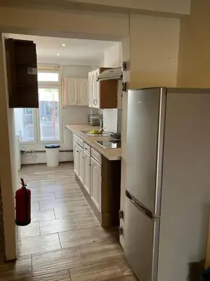 a kitchen with white cabinets and a refrigerator at Expats House 10 Stabroek Belgium in Stabroek