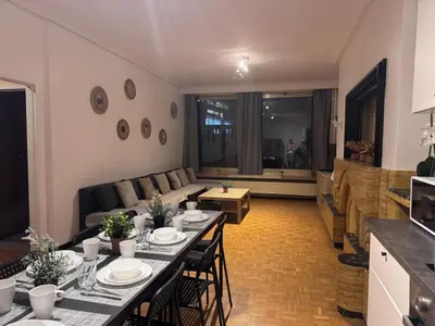 a living room with a table and a couch at Simon Apartment in Antwerp
