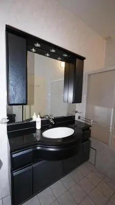 a bathroom with a black sink and a mirror at Simon Apartment in Antwerp