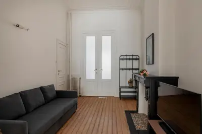 a living room with a couch and a table at Brussels Benit Ixelles House in Brussels