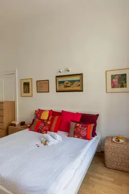 a bedroom with a white bed with red pillows at Brussels Benit Ixelles House in Brussels