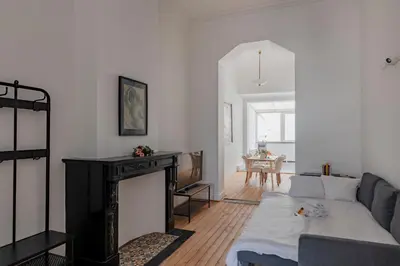 a living room with a couch and a fireplace at Brussels Benit Ixelles House in Brussels